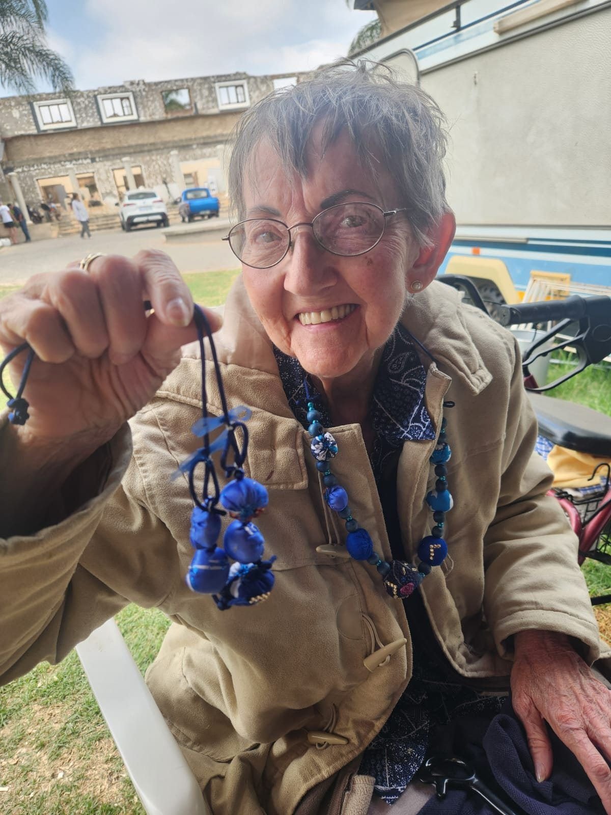 A resident proudly showing a bead necklace she made